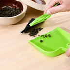 Durable plastic dustpan with matching brush, a convenient cleaning tool.