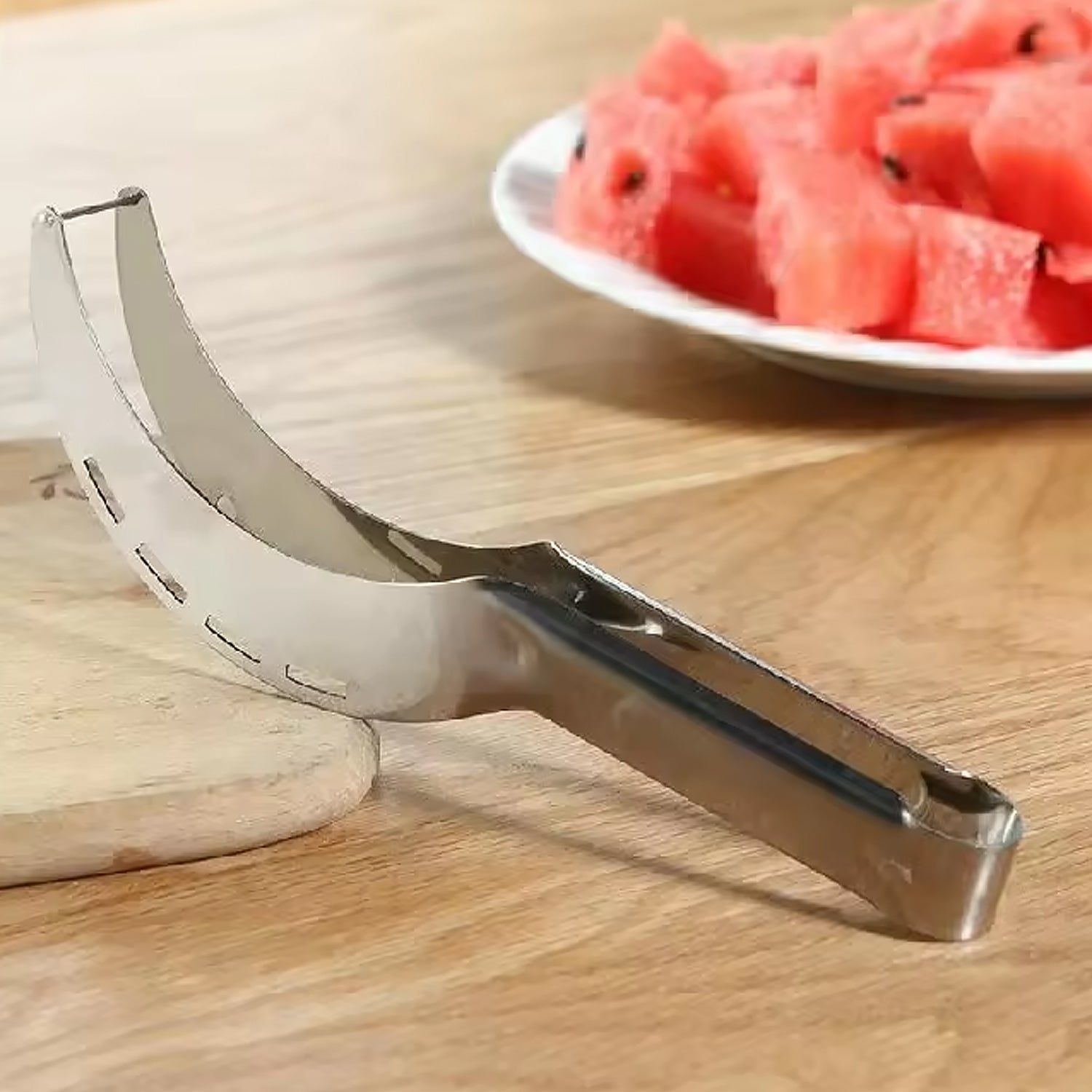 The versatile stainless steel watermelon corer and slicer with fresh fruit pieces.