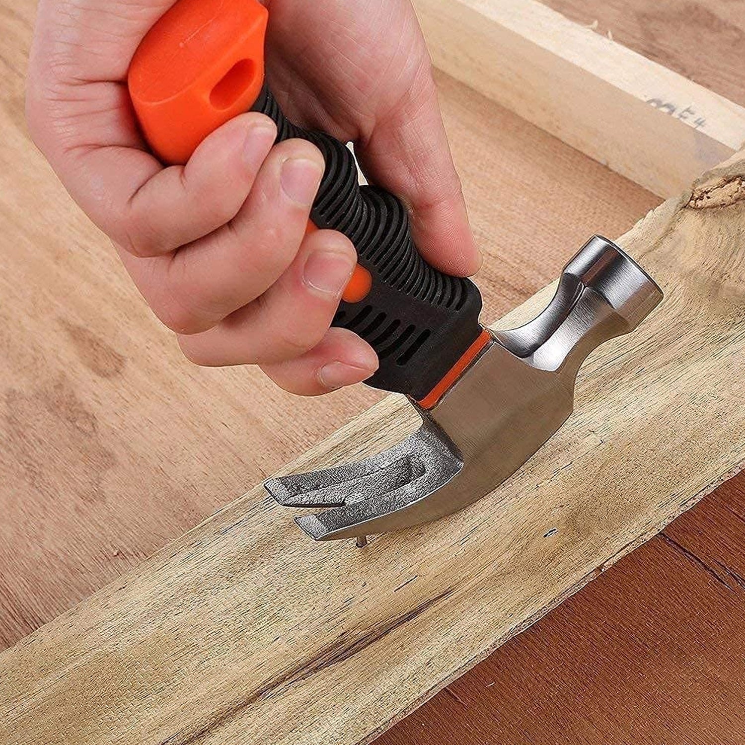 The compact mini claw hammer displayed next to a measuring tape, showing its 15 cm length.
