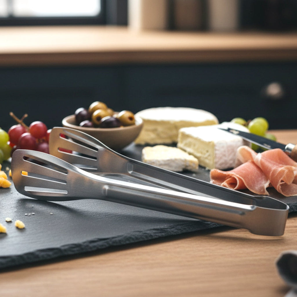Salad being served using stainless steel kitchen serving tongs