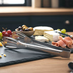 Salad being served using stainless steel kitchen serving tongs