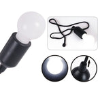 Close-up of the black LED bulb, showing its pull cord mechanism.