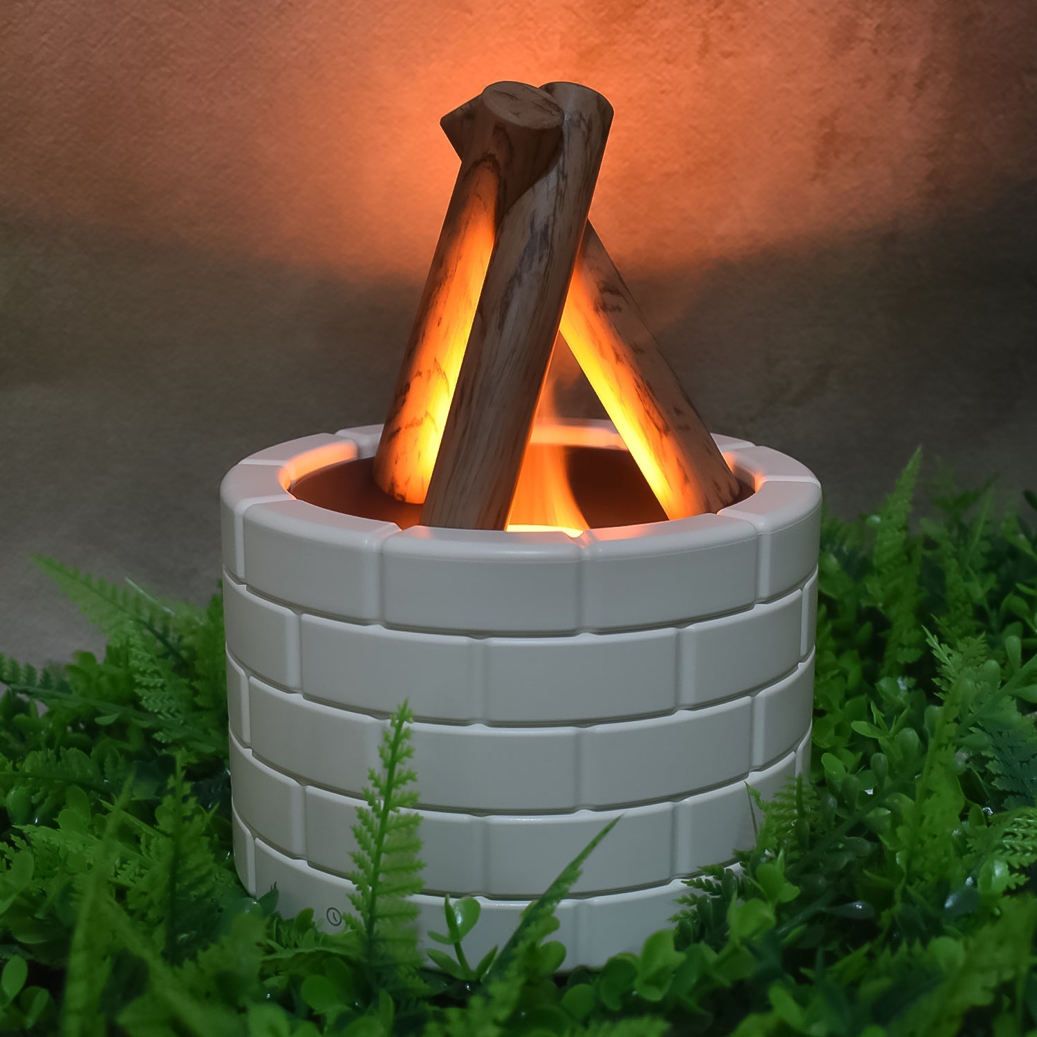 Detailed view of the Flame Diffuser's mist outlet and glowing bonfire light.