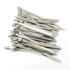 An array of durable stainless steel cable ties laid out, highlighting their uniform design and quality.