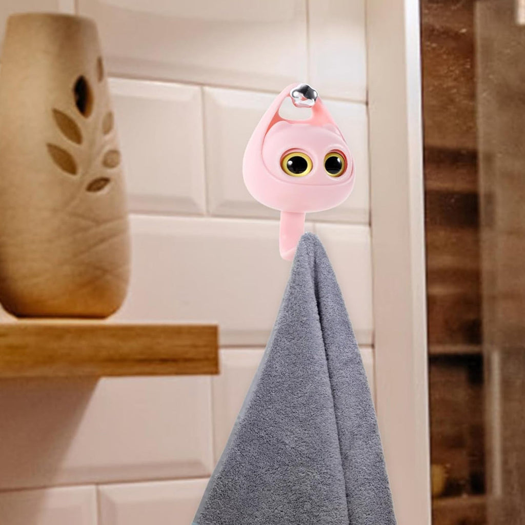 Decorative cat adhesive hook mounted on a wall, adding charm to home decor.