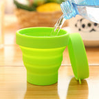 Collapsed foldable silicone travel mug with lid, ready for packing.