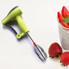 A manual hand blender being used to make a refreshing glass of lassi.