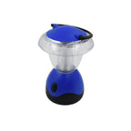 The Indo Glow Mini Camping Lantern emitting a powerful white LED light in a dark environment.
