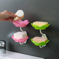 White flower-shaped self-draining soap dish holder with suction cup for bathroom use.