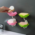 White flower-shaped self-draining soap dish holder with suction cup for bathroom use.