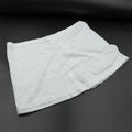 Women's high-waisted athletic skort front view in white.