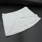 Women's high-waisted athletic skort front view in white.