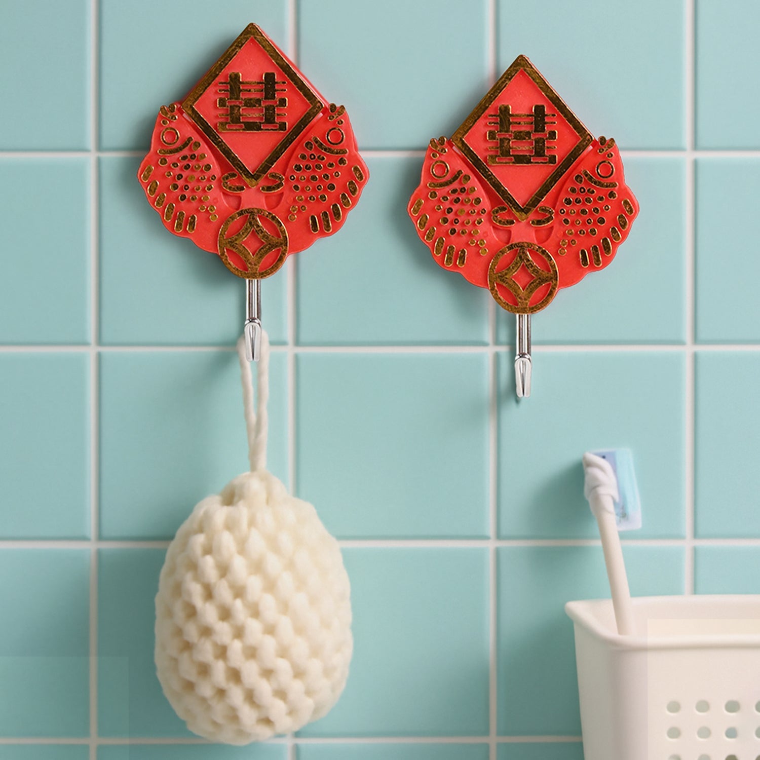 A GlimmerHome wall hook holding a pair of scissors, demonstrating its versatile use.