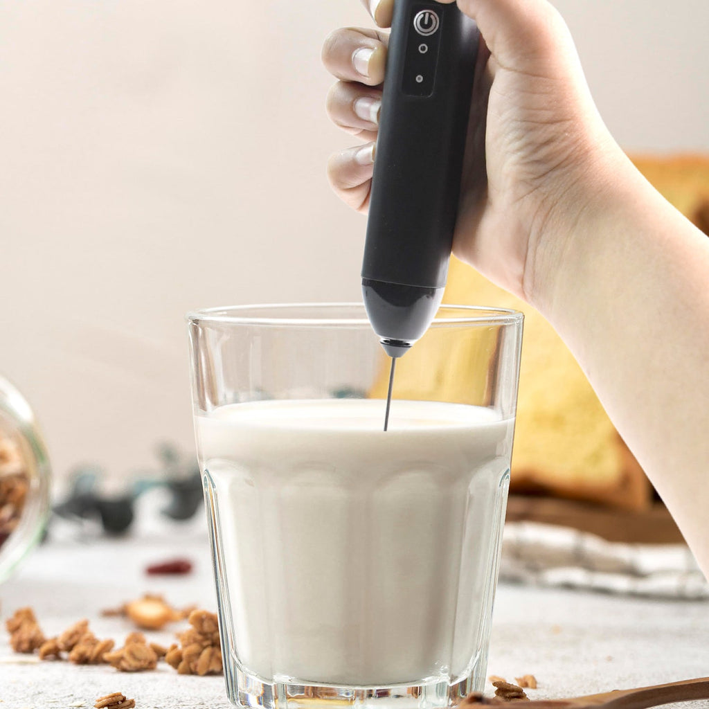 Closeup of stainless steel whisk on electric handheld milk frother