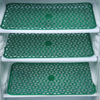 Fridge drawer mats preventing spills and scratches.