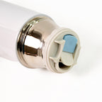 Compact stainless steel vacuum bottle holding hot coffee