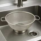 Side profile of stainless steel strainer colander with comfortable handles