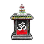 Small Om Temple elegantly placed in a home mandir setting.