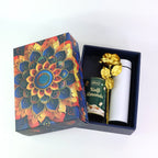 Stainless steel bottle included in Kulfi almonds gift hamper with an elegant golden rose