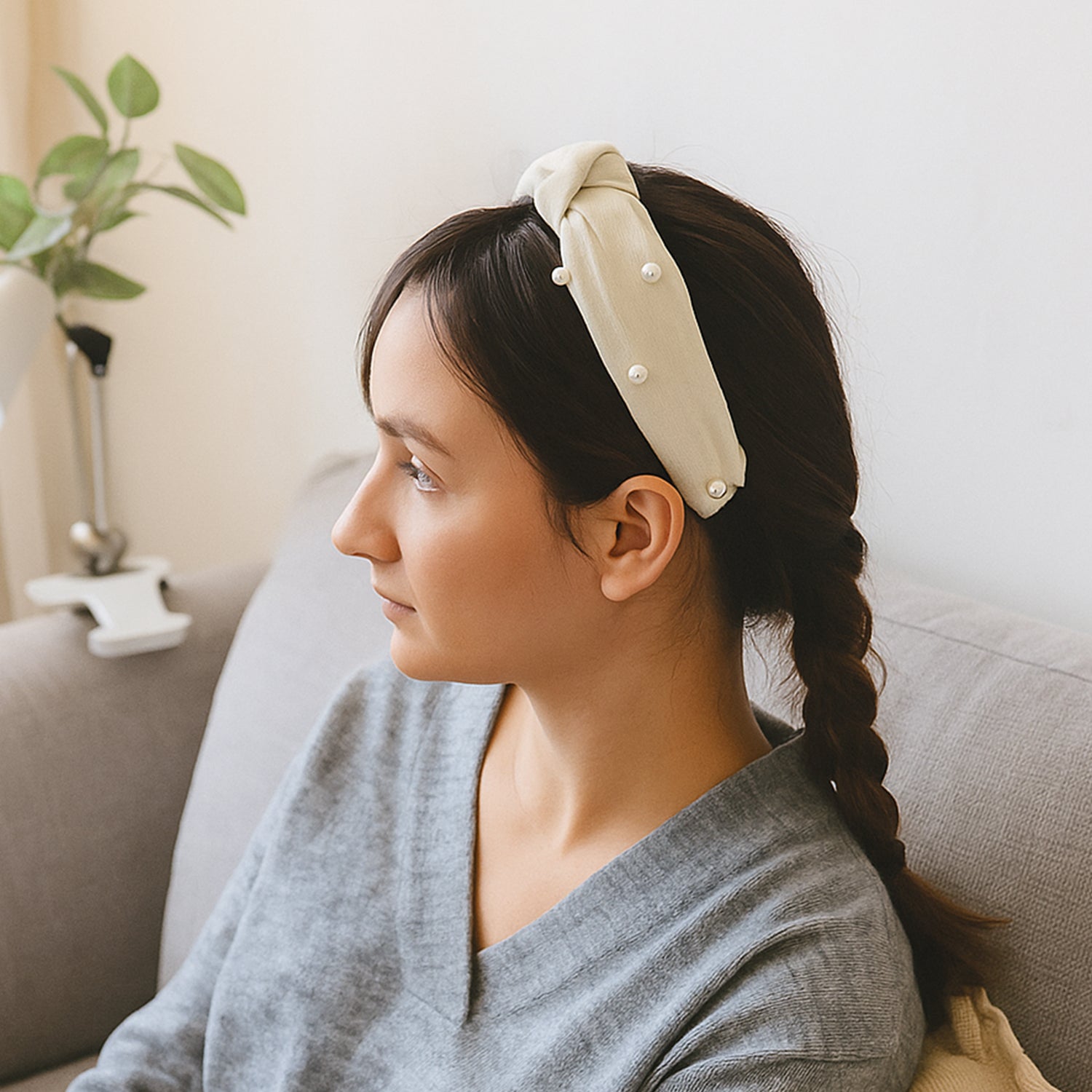 Woman wearing soft ribbed knot hairband with padded design, side view