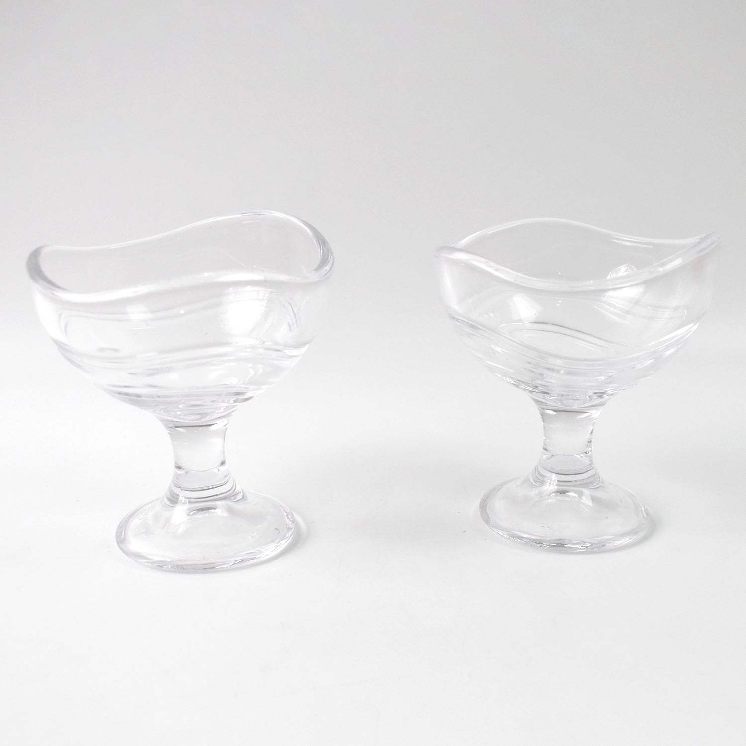 Clear glass dessert bowl highlighting its sturdy footed base.