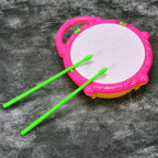 The Flash Drum Toy glowing with an array of colorful lights in a playful setting.