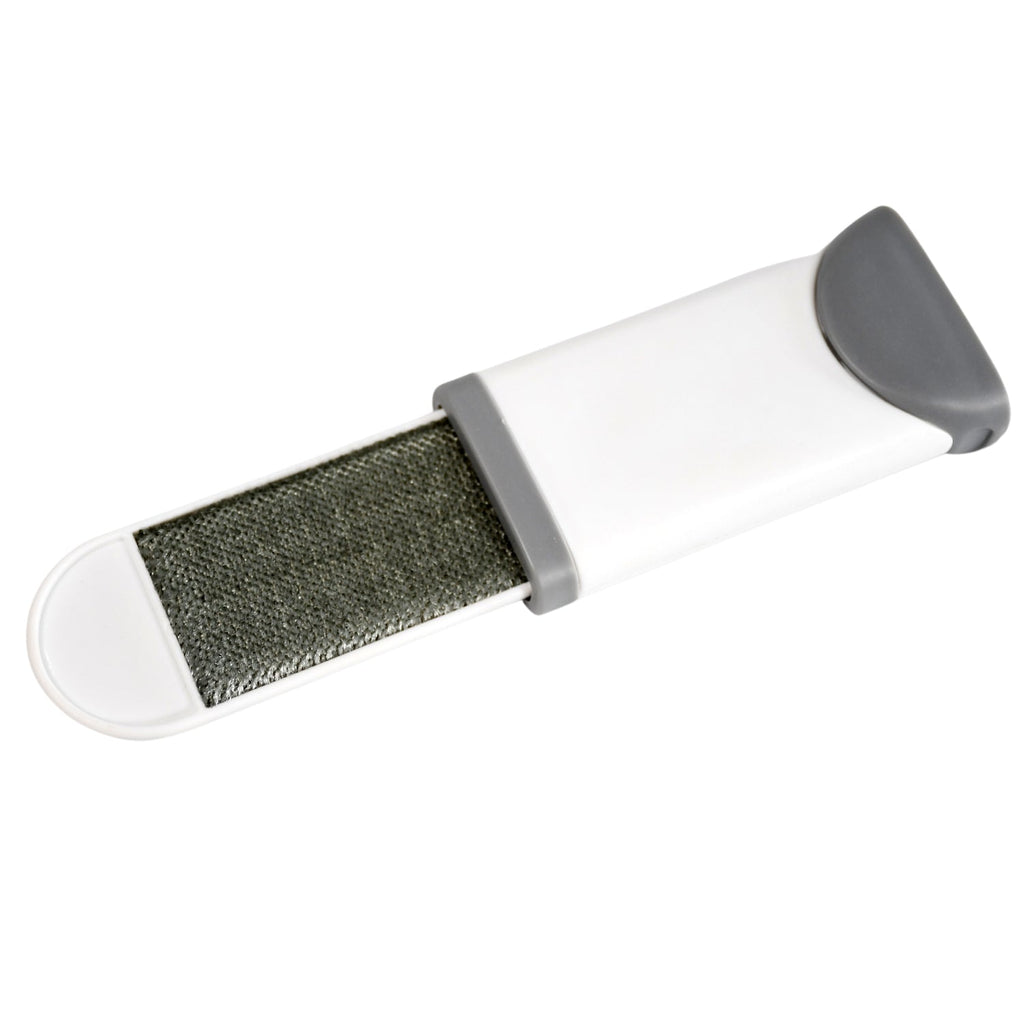 Lint remover brush effectively picking up pet fur from an upholstered couch.