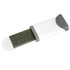Lint remover brush effectively picking up pet fur from an upholstered couch.