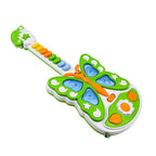 A young child's hands exploring the buttons of the light and music guitar toy.