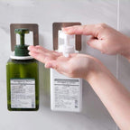 Versatile strong sticky hook holding a power plug, demonstrating multi-use.