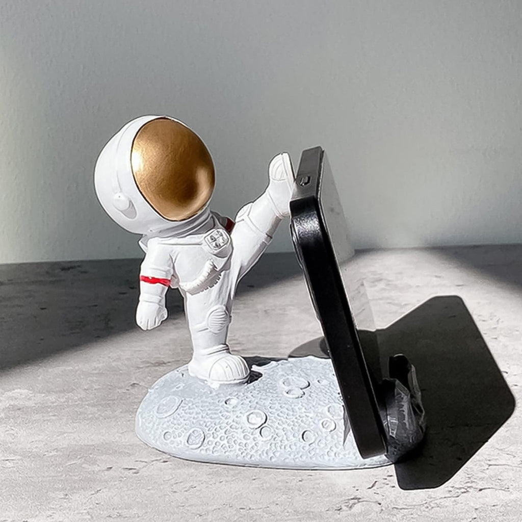 Astronaut Phone Holder with a phone, demonstrating its stable and secure base.