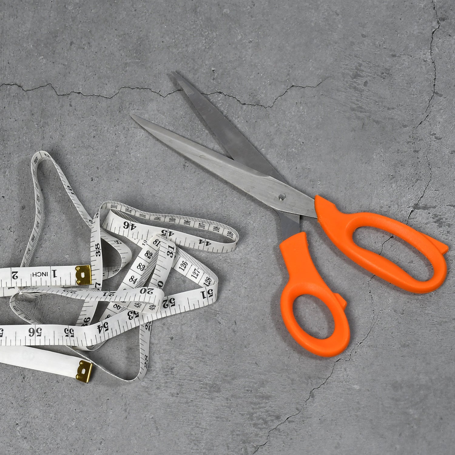 An overhead shot of the tailor scissors and measuring tape, ready for tailoring projects.
