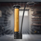 Detailed close-up of the hand air pump's nozzle and needle, ready for ball inflation.