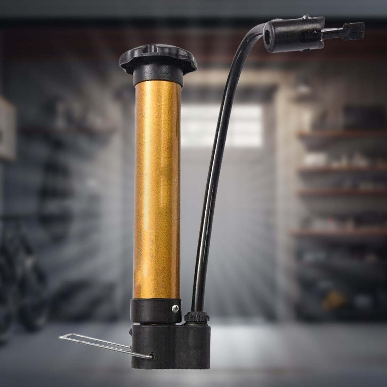 Detailed close-up of the hand air pump's nozzle and needle, ready for ball inflation.