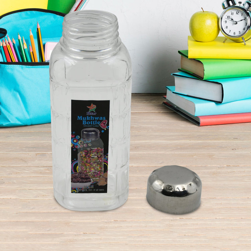 Plastic mukhwas bottle placed next to a bowl of dry fruits