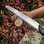 Folding handsaw with SK5 steel blade, ready for precise tree trimming.