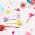 Collection of 12 fun cartoon and heart design ballpoint pens with rattles.