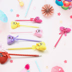 Collection of 12 fun cartoon and heart design ballpoint pens with rattles.