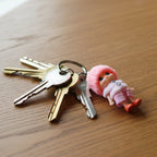 Close-up of mini doll keychain highlighting craftsmanship