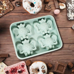Multiple cartoon silicone ice cube trays stacked, highlighting their compact storage.