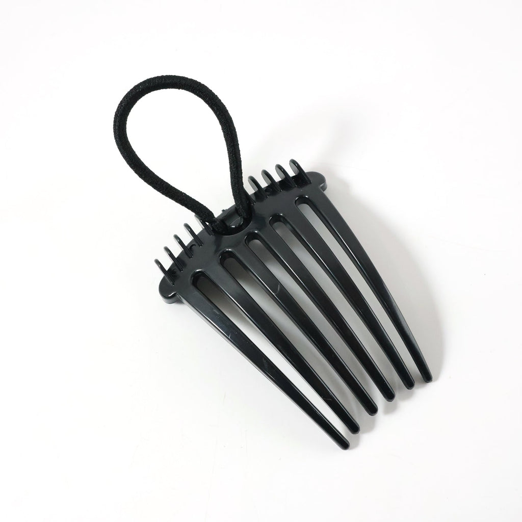Hair styling comb clip securing hair in a voluminous bun style