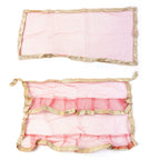 Red pooja cloth with gold border wound as net wrap for tulsi plant adorning