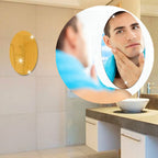 Multiple Styleva oval mirror stickers creating an artistic wall display.