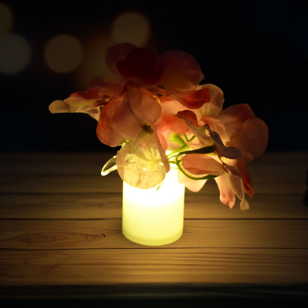 An LED flower light standing on a tabletop, highlighting its compact size.
