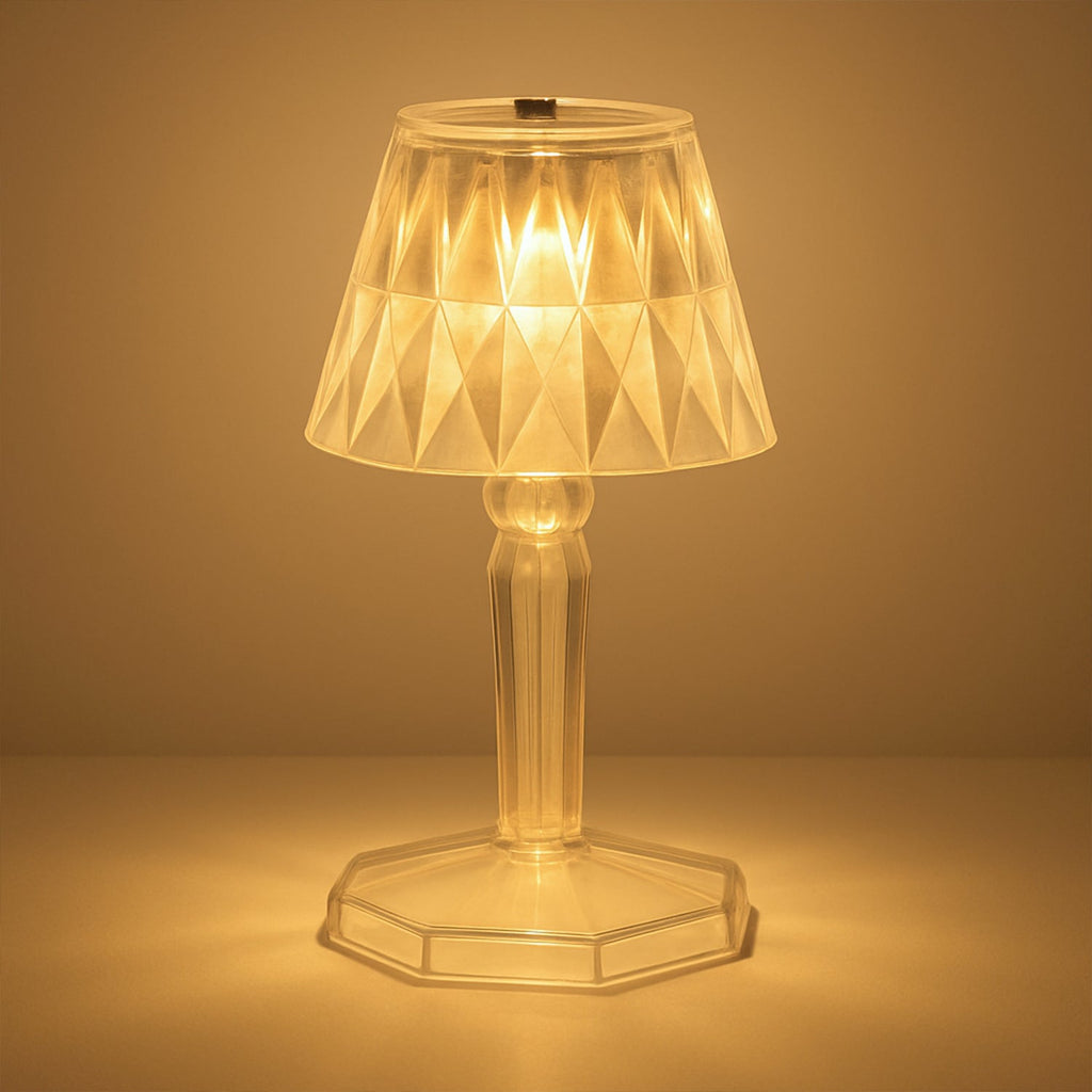 A detailed view of the acrylic crystal table lamp on a wooden surface.