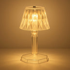 A detailed view of the acrylic crystal table lamp on a wooden surface.