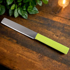 Top view of vegetable peeler and grater from kitchen cutting set