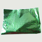 Person wrapping a present using metallic gift wrapping paper with stars