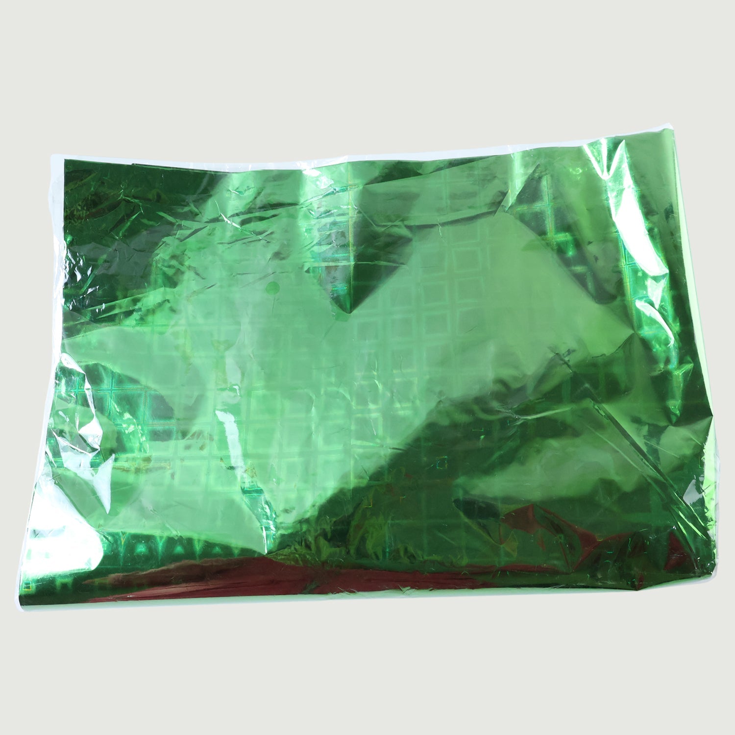 Person wrapping a present using metallic gift wrapping paper with stars