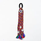 Hair accessory featuring braided fabric threads and shell embellishments
